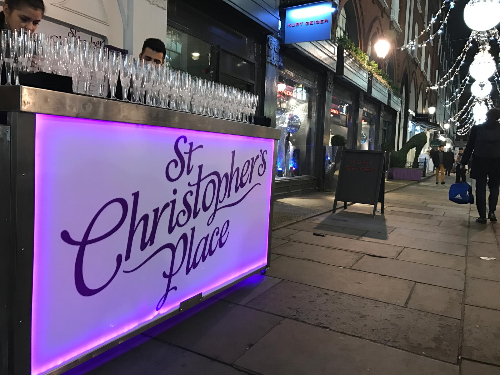 St Christopher's Place branded illuminated mobile bar set up on a city street event
