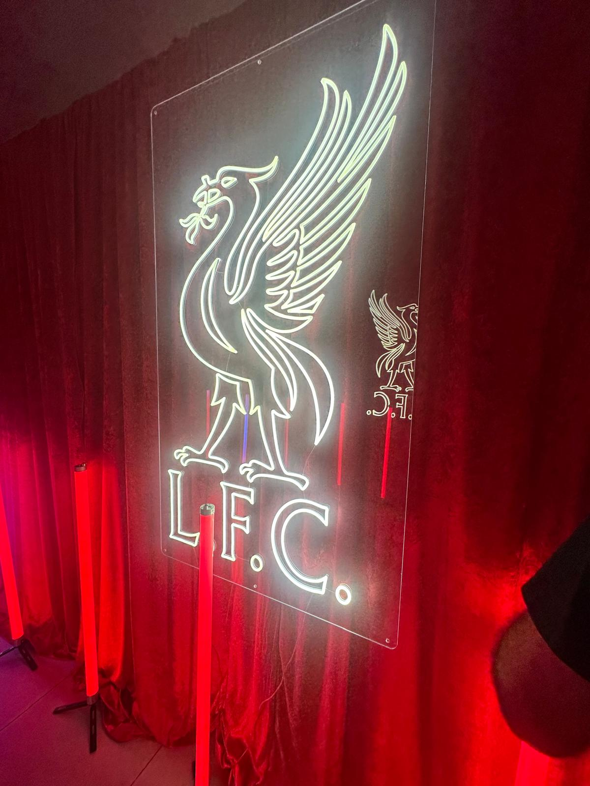 Liverpool FC neon crest backdrop used inside a sponsor activation space