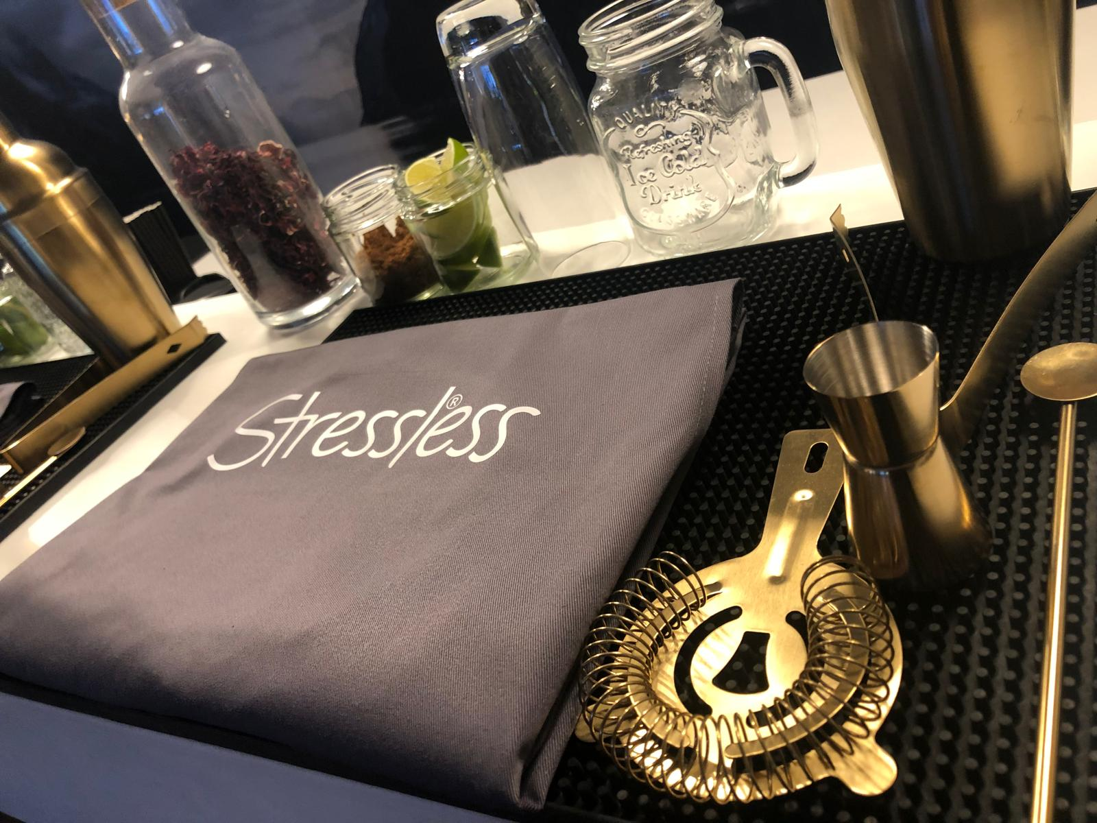 Close-up of cocktail masterclass bar tools, garnishes and branded apron ready for the session