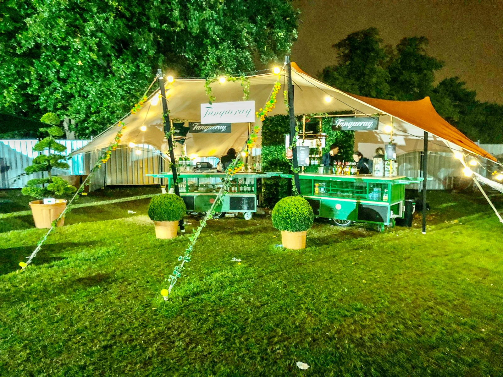 Tanqueray branded gin bar inside a stretch tent at an evening sponsor activation