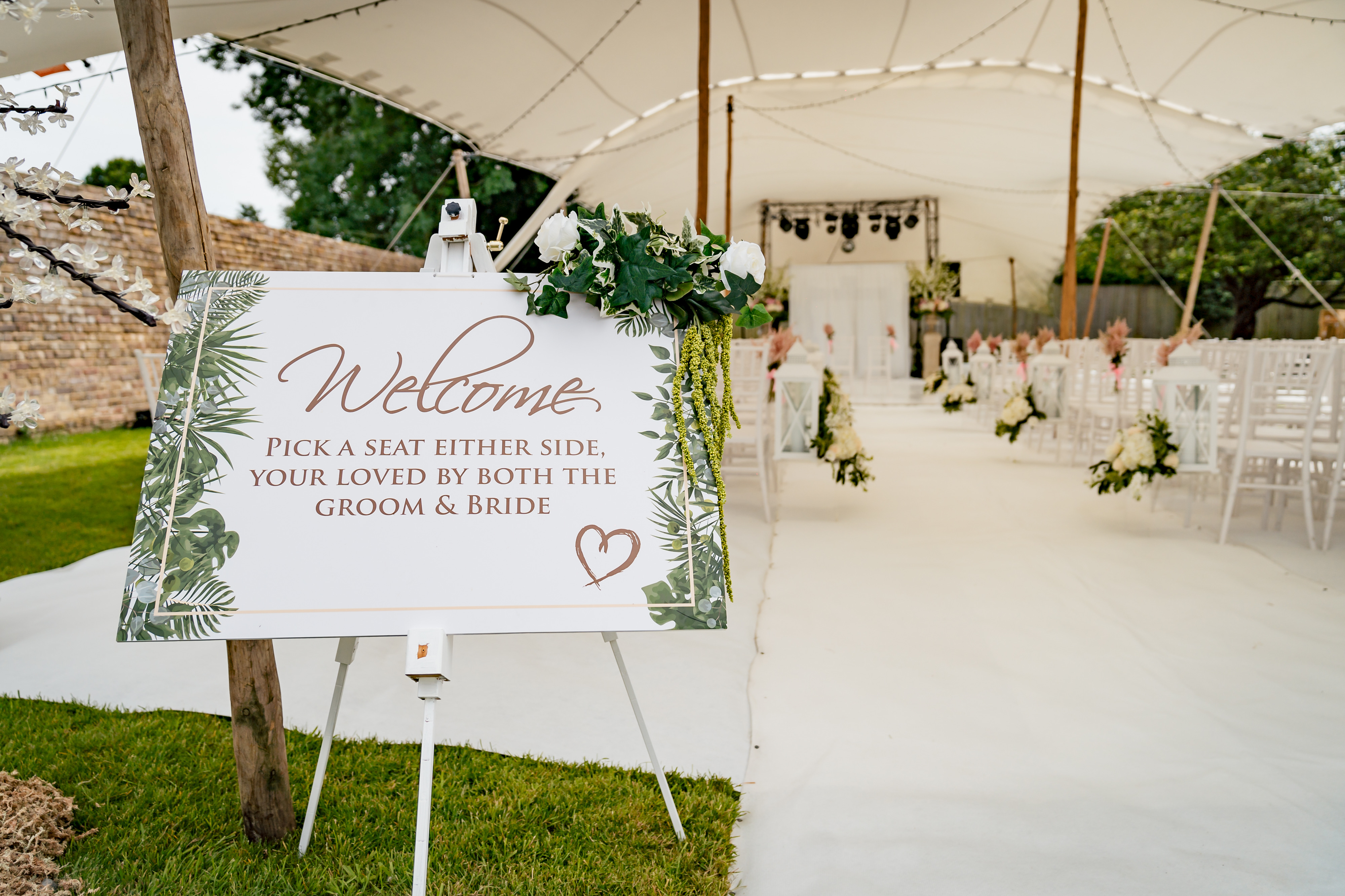Hand-lettered welcome sign from our hire catalogue dressed at a wedding entrance