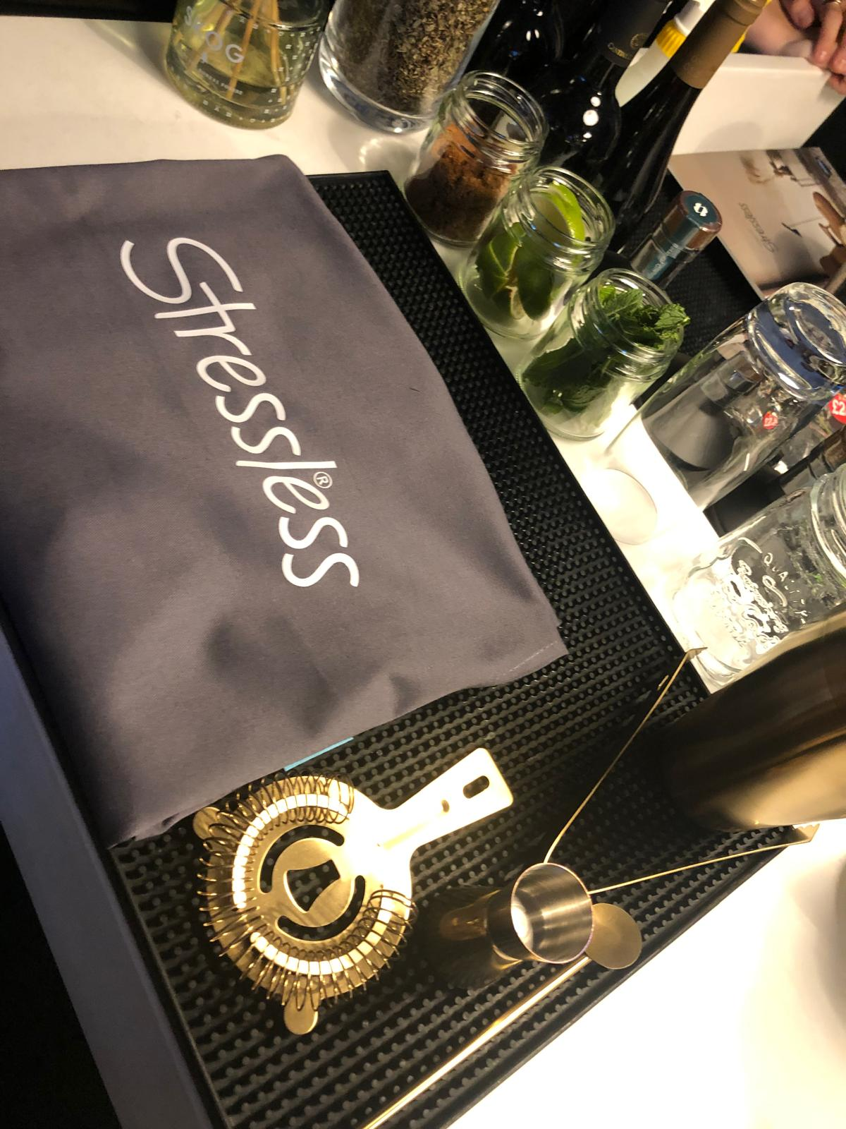 Detail shot of cocktail masterclass ingredients, bar tools and branded apron on the station