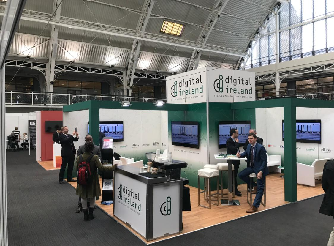 Wide view of the Digital Ireland exhibition stand with integrated barista coffee bar and branded counter