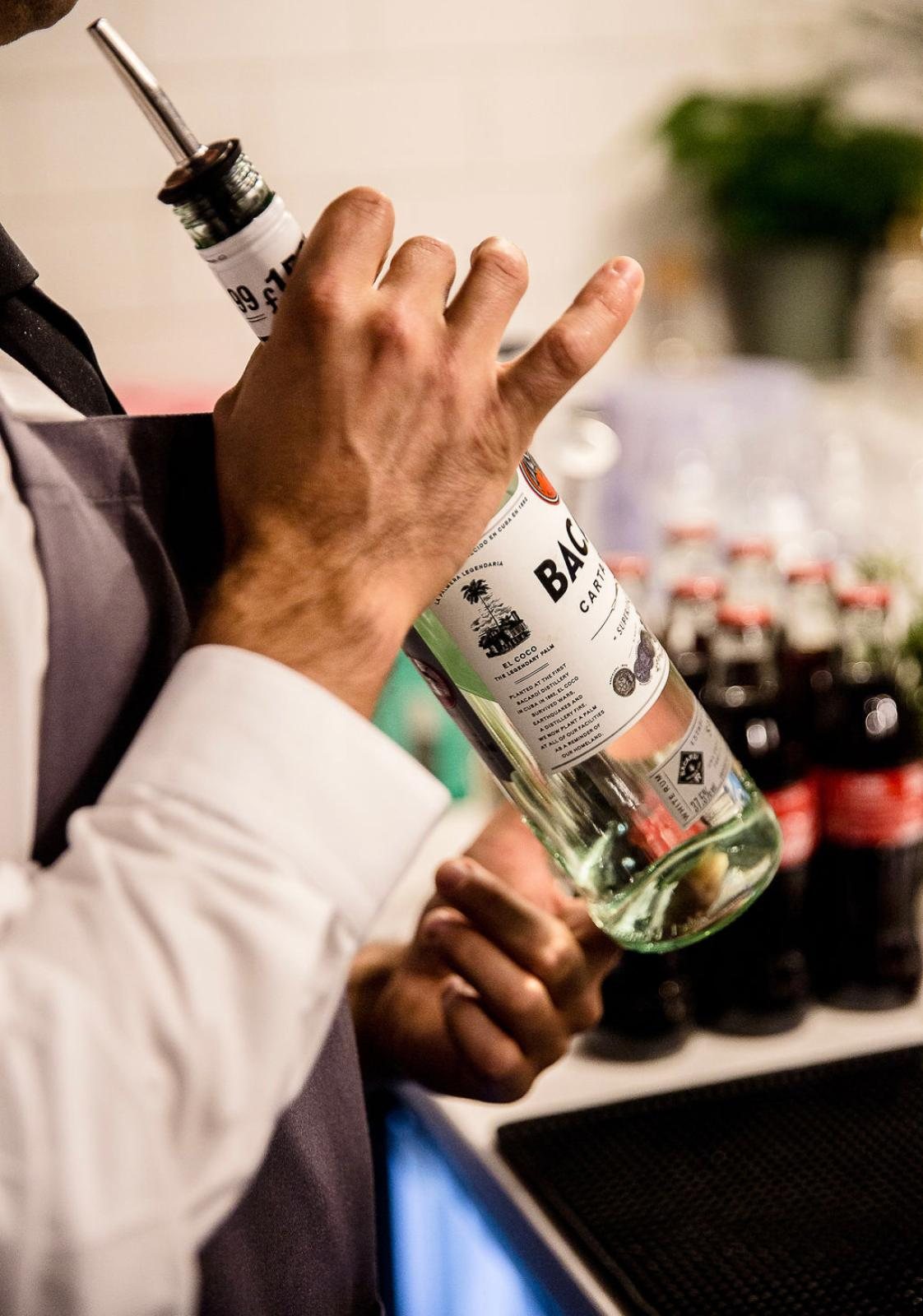 Close-up of a bartender pouring Bacardi during cocktail service