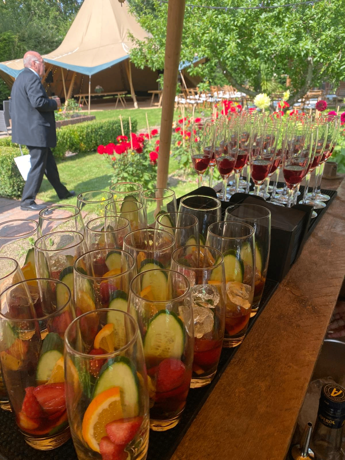 Pimms with cucumber and orange alongside raspberry prosecco at a tipi wedding drinks reception