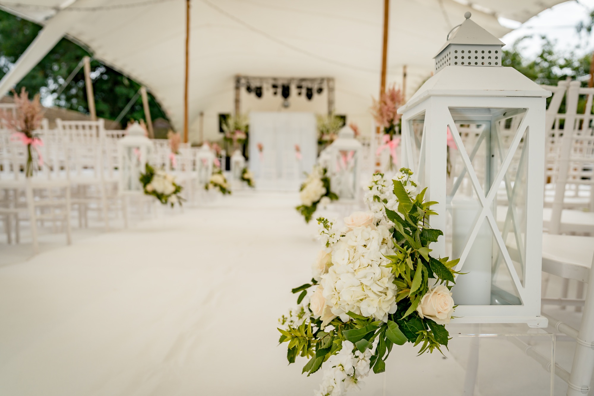 Aisle lanterns from our hire catalogue dressed at an outdoor wedding ceremony